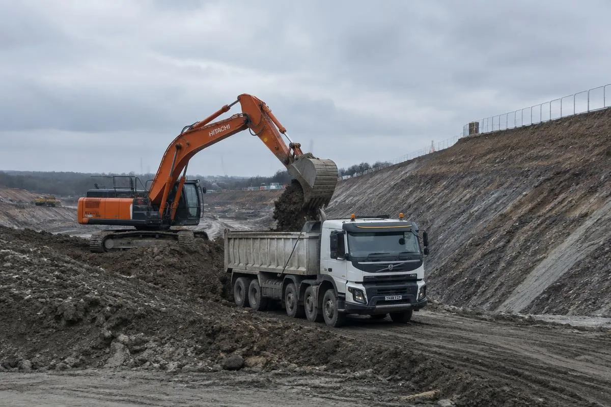 Excavator loading a tipper truck during bulk excavation on a civil site